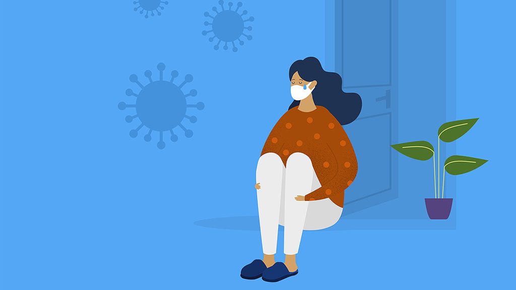 一个带着面具的泪流满面的女人坐在家里的门廊上